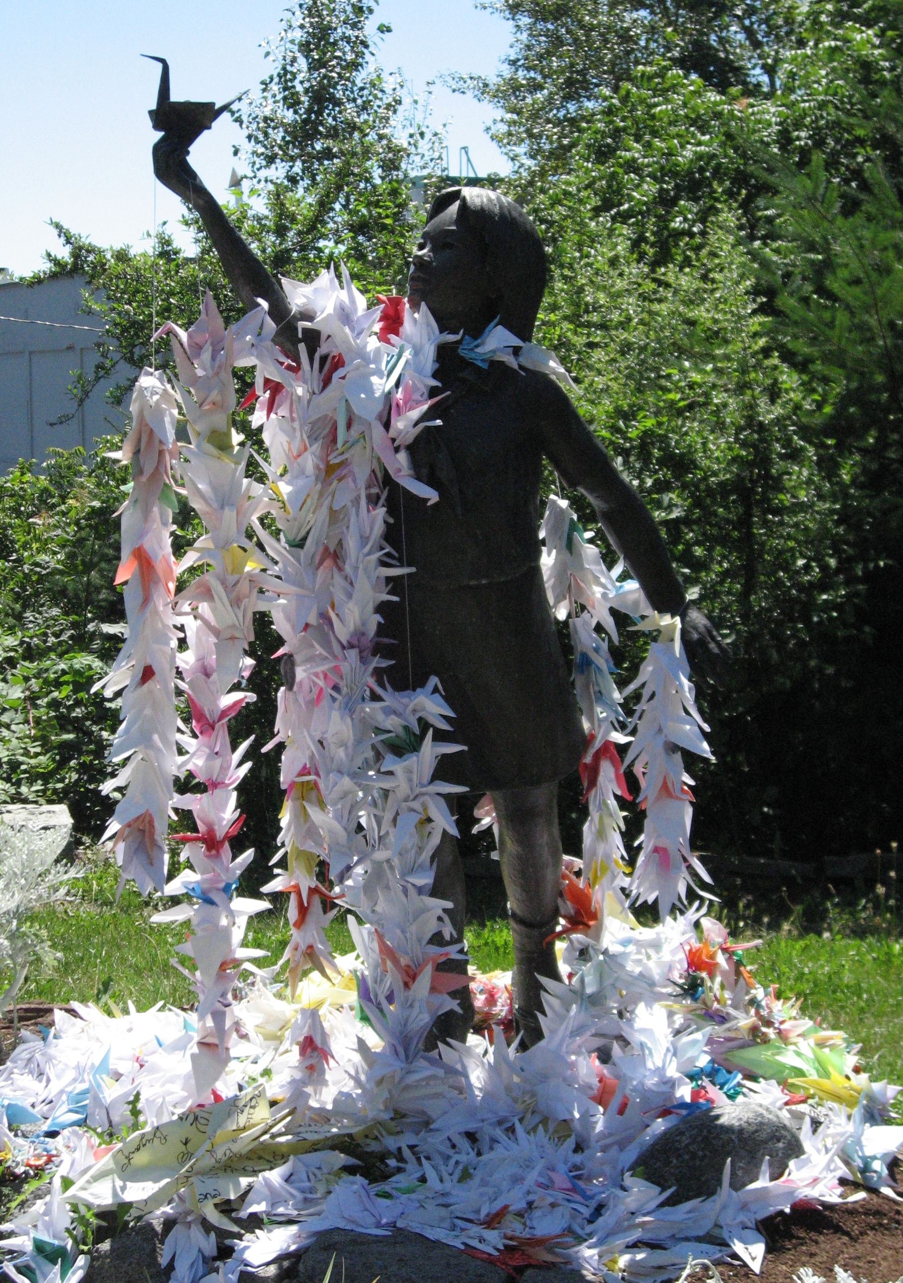 Bronzestatue von Sadako Sasaki im Seattle Peace Park, behängt mit Origami-Kranichen als Symbol der Friedensbewegung
