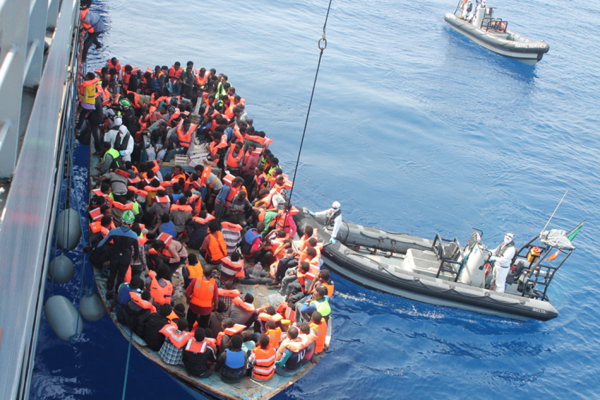 Flüchtlinge im Mittelmeer vor ihrer Aufnahme durch ein Kriegsschiff
